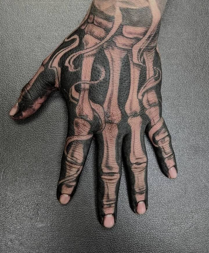 Black Ink And Negative Spaces Skeleton Hand Tattoo