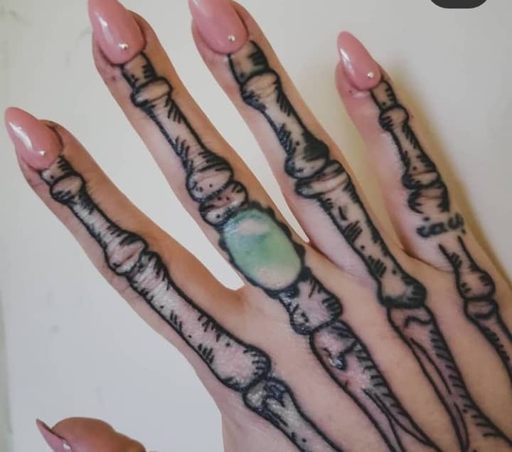 Emerald Stone And Skeleton Hand Tattoo