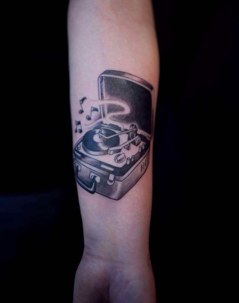 A Tattoo of a Record Player With a Vinyl Record